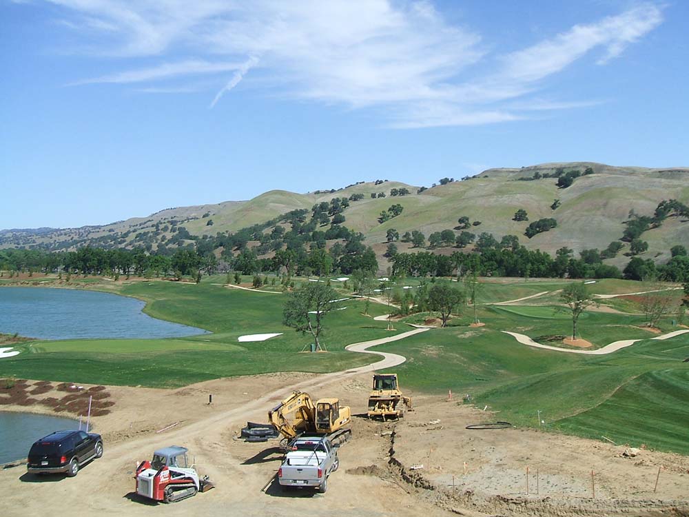 aerial view of construction equipment working on a golf course